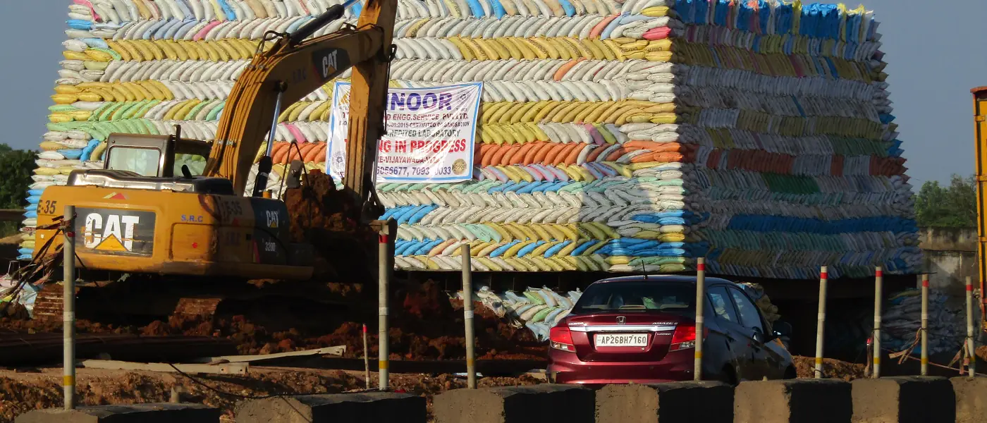 Bags of cement stacked beside a highway in Andhra Pradesh