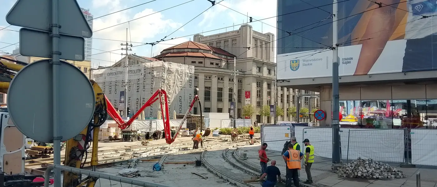 Workers pouring and levelling fresh concrete