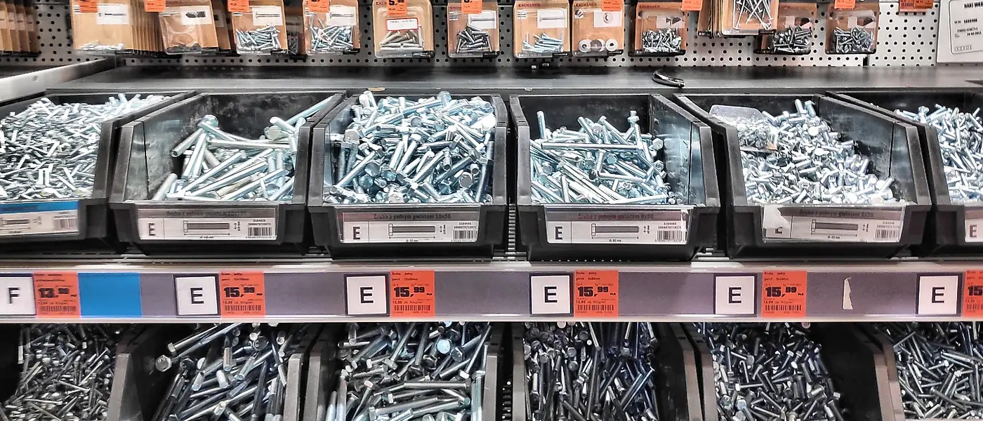 Bins of screws and bolts on hardware store shelves