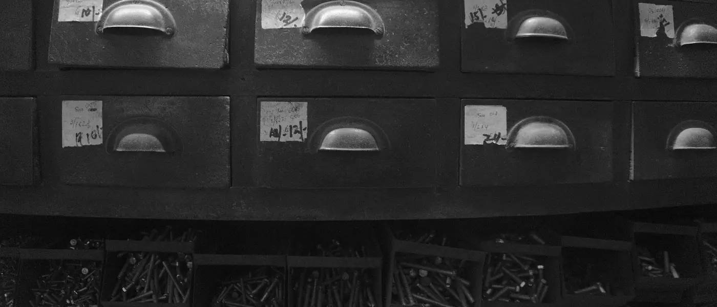 Labelled drawers and bins of screws in a hardware store in Panjim, Goa